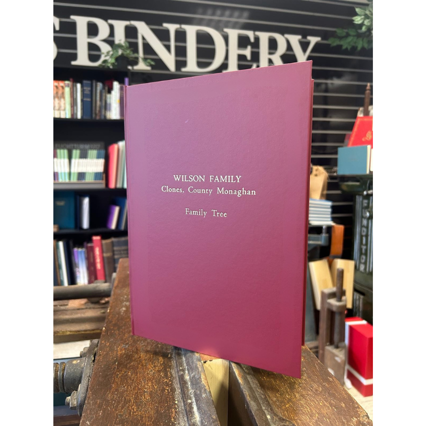 A handcrafted family history book bound in red buckram cloth, custom printed and made in Auckland, New Zealand.